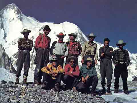 
Gasherbrum I Hidden Peak First Ascent - The expedition poses in front of Gasherbrum I (Hidden Peak) at Base Camp after the first ascent in 1958.
Behind the team is Gasherbrum I (Hidden Peak) above the Abrruzzi Glacier. The summit on the left, Hidden South in the middle, and the Roch ridge used by the expedition on the far right.
Front, left to right: Bob Swift, Tom Nevison, Dick Irvin. Rear: Mohd Akram, Gil Roberts, Ras Rizvi, Pete Schoening, Nick Clinch, Andy Kauffman, Tom McCormack. - A Walk In The Sky book
